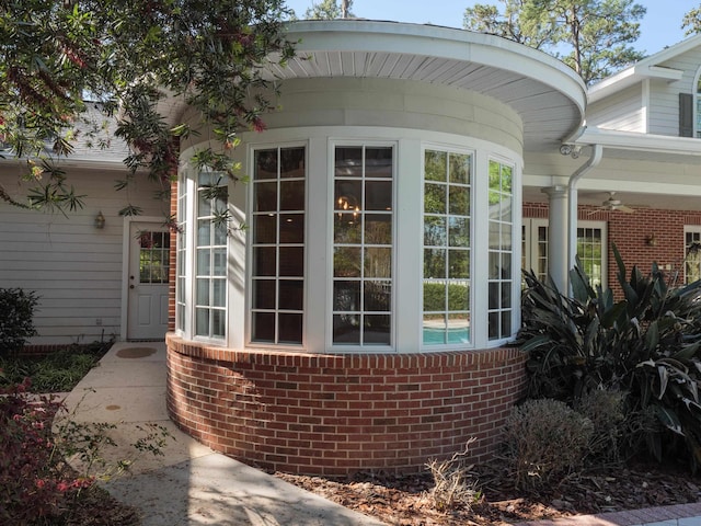 property entrance with ceiling fan