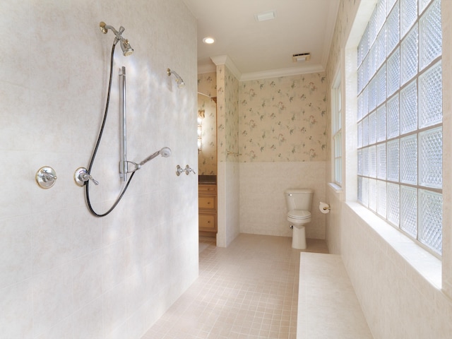 bathroom featuring toilet, tile patterned floors, tile walls, and ornamental molding