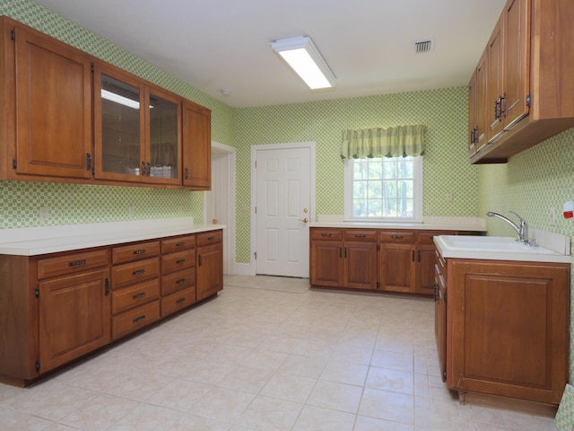 kitchen featuring light tile patterned flooring and sink