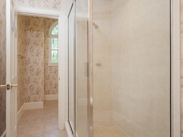 bathroom featuring tile patterned floors and a shower with door