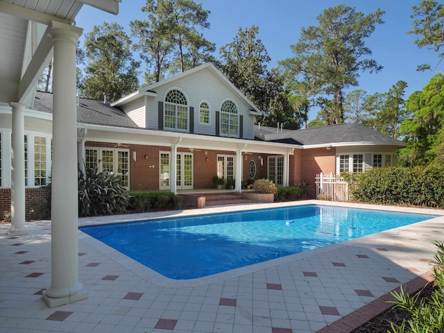 view of pool with french doors and a patio