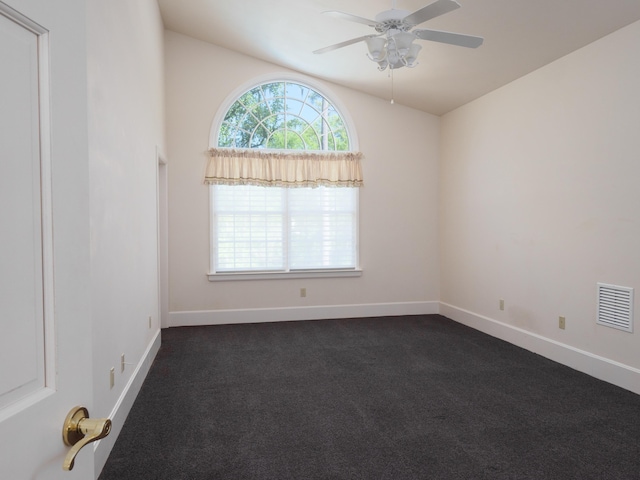 empty room featuring dark colored carpet and ceiling fan