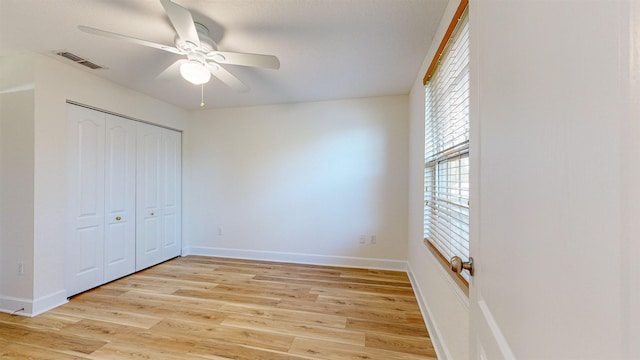 unfurnished bedroom featuring light hardwood / wood-style flooring, a closet, and ceiling fan