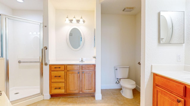 bathroom featuring a shower with door, vanity, tile patterned floors, and toilet