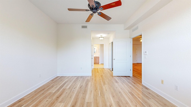 spare room with ceiling fan and light wood-type flooring