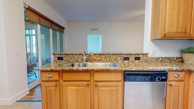 kitchen featuring sink, light tile patterned floors, stainless steel dishwasher, light stone counters, and kitchen peninsula