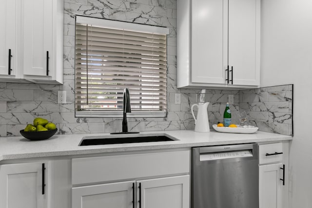 kitchen featuring white cabinets, dishwasher, decorative backsplash, and sink