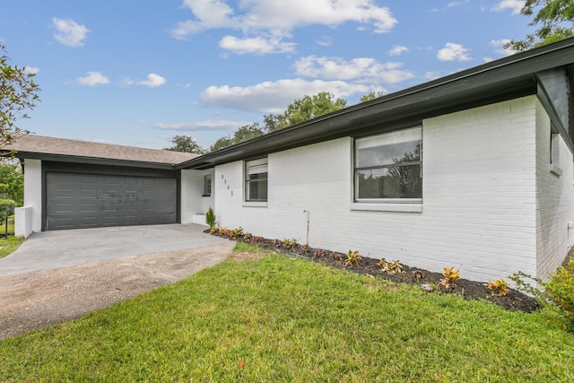 single story home with a front yard and a garage