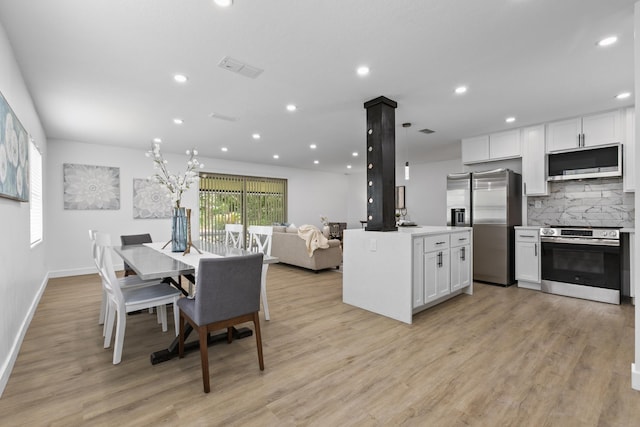 dining room with light hardwood / wood-style floors