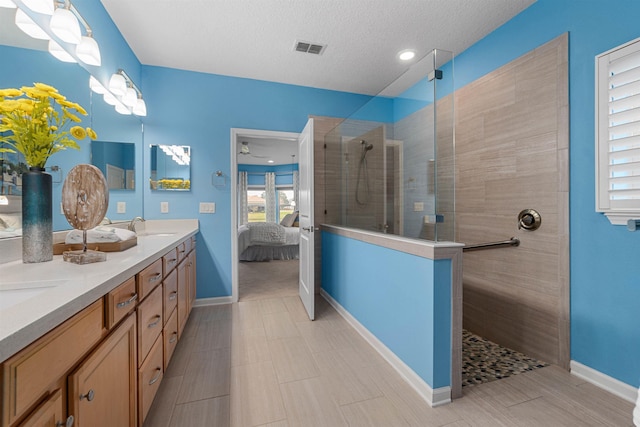 full bath featuring double vanity, visible vents, ensuite bathroom, a sink, and walk in shower