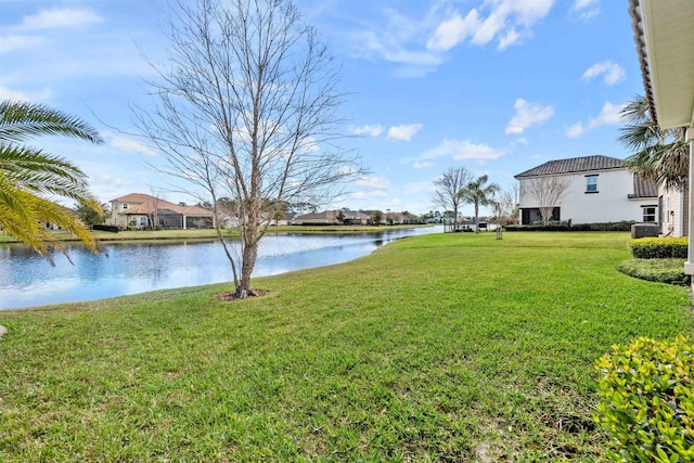 view of yard featuring a water view and central air condition unit