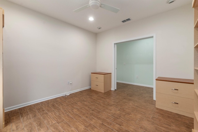 unfurnished bedroom with baseboards, visible vents, wood finished floors, and recessed lighting