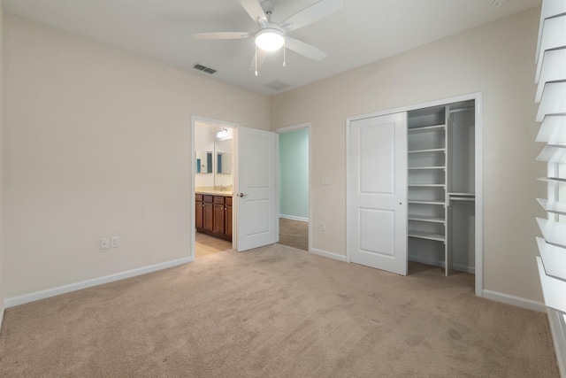 unfurnished bedroom with light carpet, a closet, visible vents, and baseboards