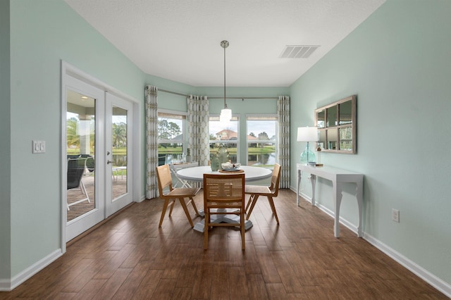 dining space featuring dark wood-style floors, baseboards, visible vents, and french doors