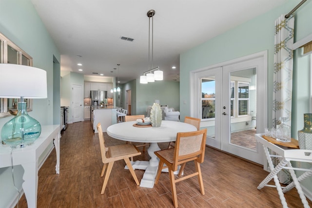 dining room with french doors, dark wood finished floors, visible vents, and recessed lighting