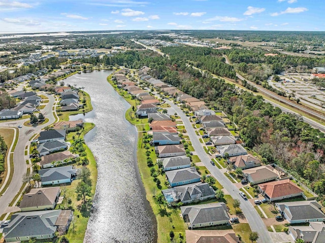 drone / aerial view with a water view and a residential view