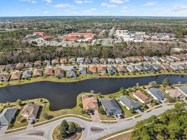 drone / aerial view with a water view and a residential view