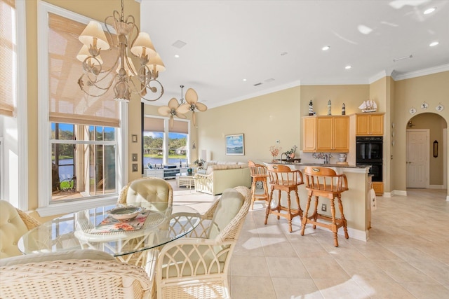 dining room featuring ornamental molding, light tile patterned floors, and a chandelier