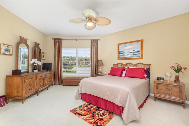 bedroom with light carpet and ceiling fan