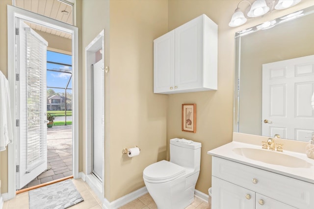 bathroom featuring walk in shower, tile patterned flooring, vanity, and toilet