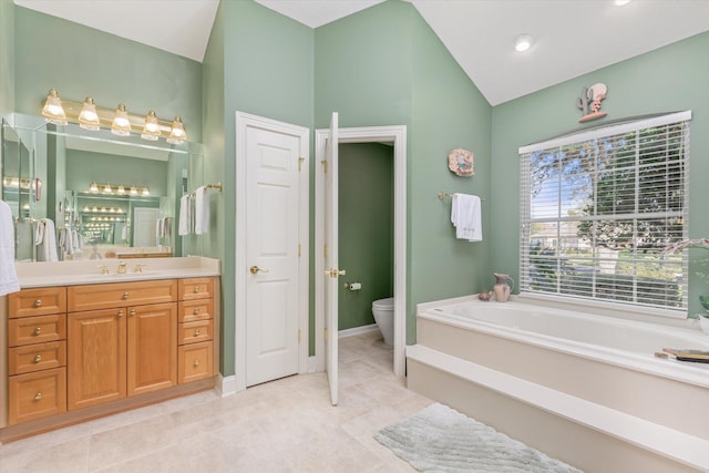 bathroom with a tub, vanity, and toilet