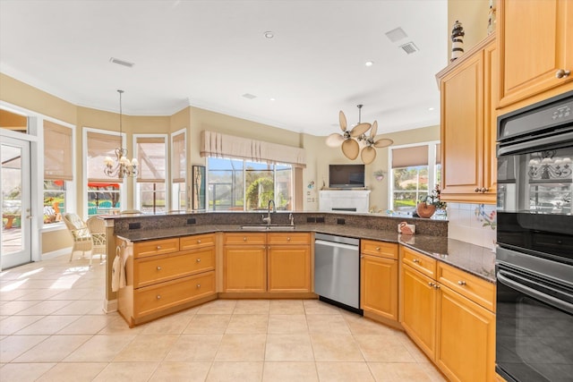 kitchen with dishwasher, sink, a wealth of natural light, and an inviting chandelier