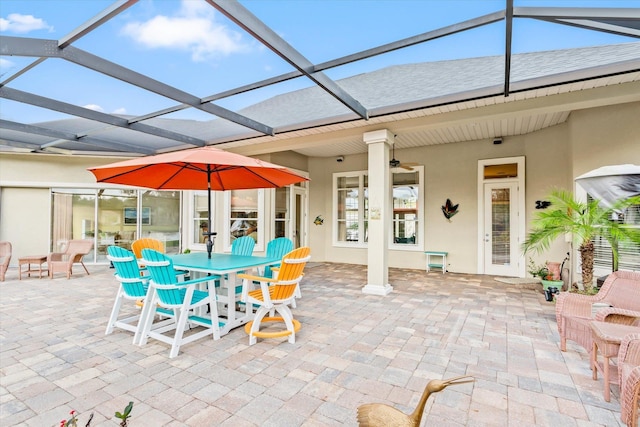 view of patio featuring a lanai and ceiling fan