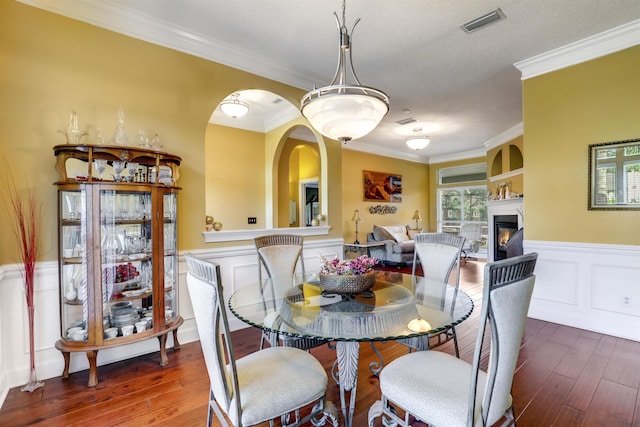 dining room featuring dark hardwood / wood-style floors and crown molding