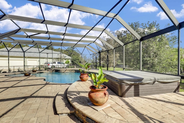 view of swimming pool with glass enclosure and a patio area