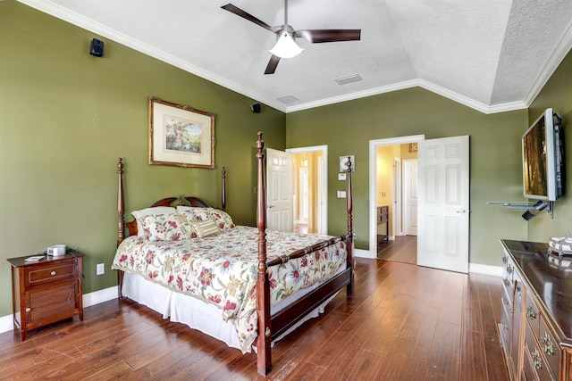 bedroom featuring ceiling fan, dark hardwood / wood-style flooring, vaulted ceiling, and ornamental molding