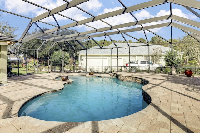 view of swimming pool featuring a lanai and a patio