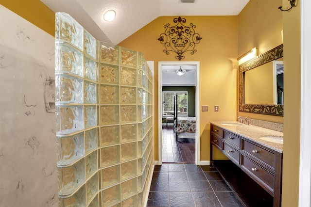 bathroom with ceiling fan, hardwood / wood-style floors, vanity, and lofted ceiling