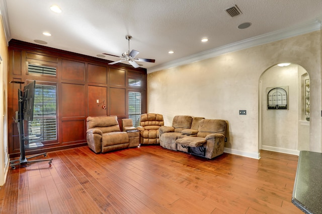 living room with a textured ceiling, hardwood / wood-style flooring, and plenty of natural light