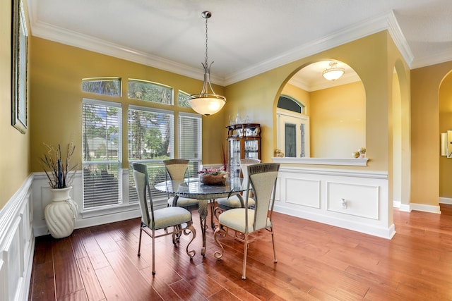 dining area featuring hardwood / wood-style floors and ornamental molding