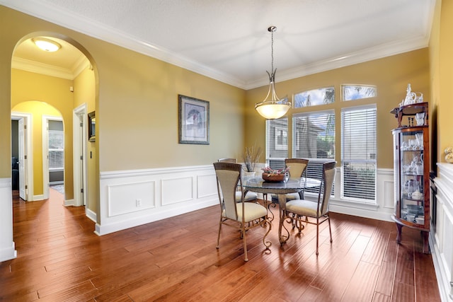 dining room with hardwood / wood-style flooring and ornamental molding