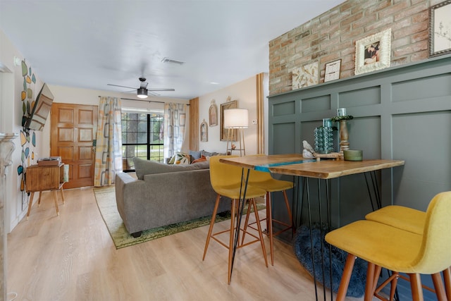 living room with ceiling fan and light hardwood / wood-style floors