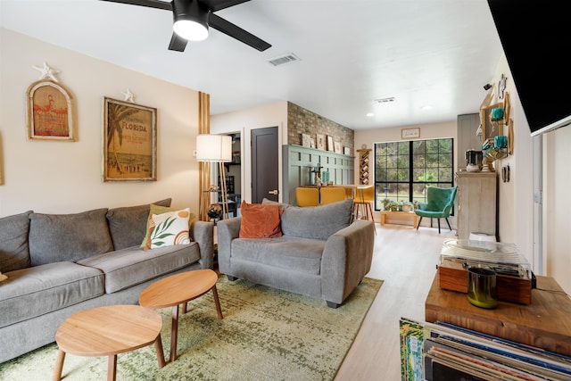 living room featuring light hardwood / wood-style flooring and ceiling fan