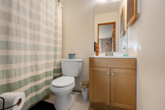 bathroom featuring toilet, vanity, and tile patterned floors