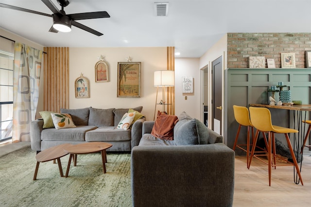 living room with ceiling fan and light hardwood / wood-style flooring