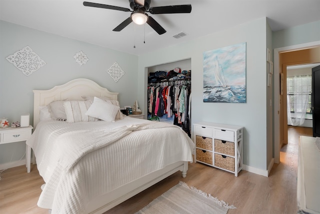 bedroom with light wood-type flooring, a closet, and ceiling fan