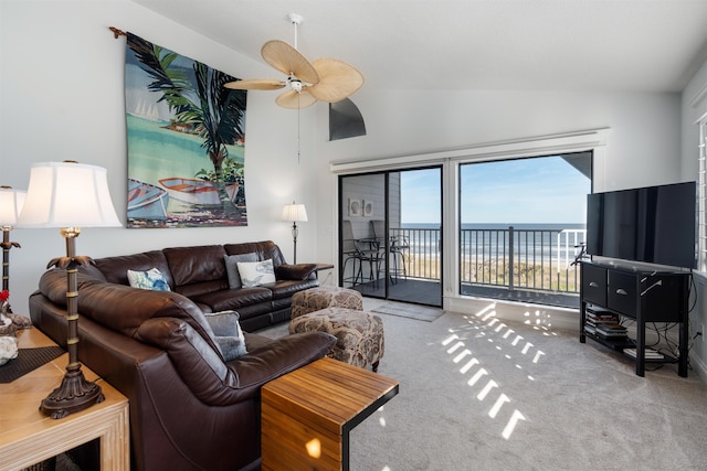 carpeted living room featuring ceiling fan and vaulted ceiling