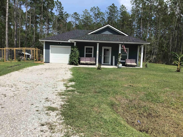 view of front of home with a porch, a garage, and a front yard