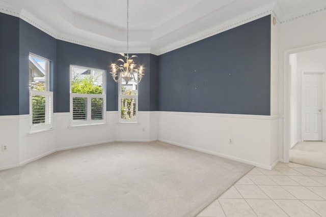 spare room with a chandelier, baseboards, tile patterned flooring, and carpet flooring