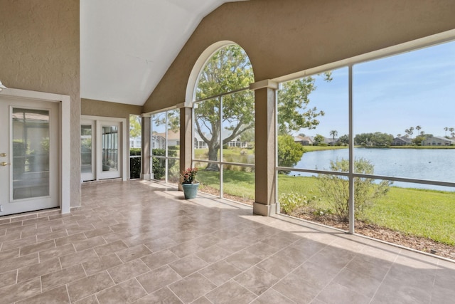 unfurnished sunroom featuring a water view and a wealth of natural light