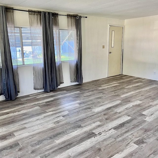 unfurnished room with wood finished floors