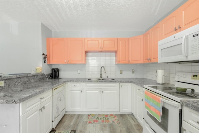 3372 9th St, Elkton, FL 32033 - kitchen featuring white appliances, decorative backsplash, a sink, and light wood-type flooring