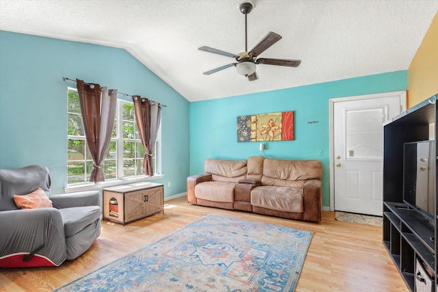 3372 9th St, Elkton, FL 32033 - living area featuring a ceiling fan, a textured ceiling, lofted ceiling, and light wood-style flooring