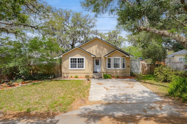 3372 9th St, Elkton, FL 32033 - bungalow-style home with fence and a front lawn