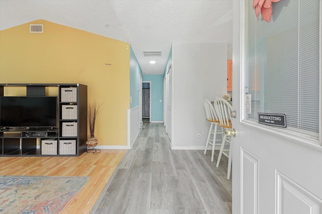 3372 9th St, Elkton, FL 32033 - interior space featuring baseboards, a textured ceiling, wood finished floors, and visible vents