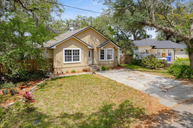3372 9th St, Elkton, FL 32033 - view of front facade with stucco siding, fence, and a front yard